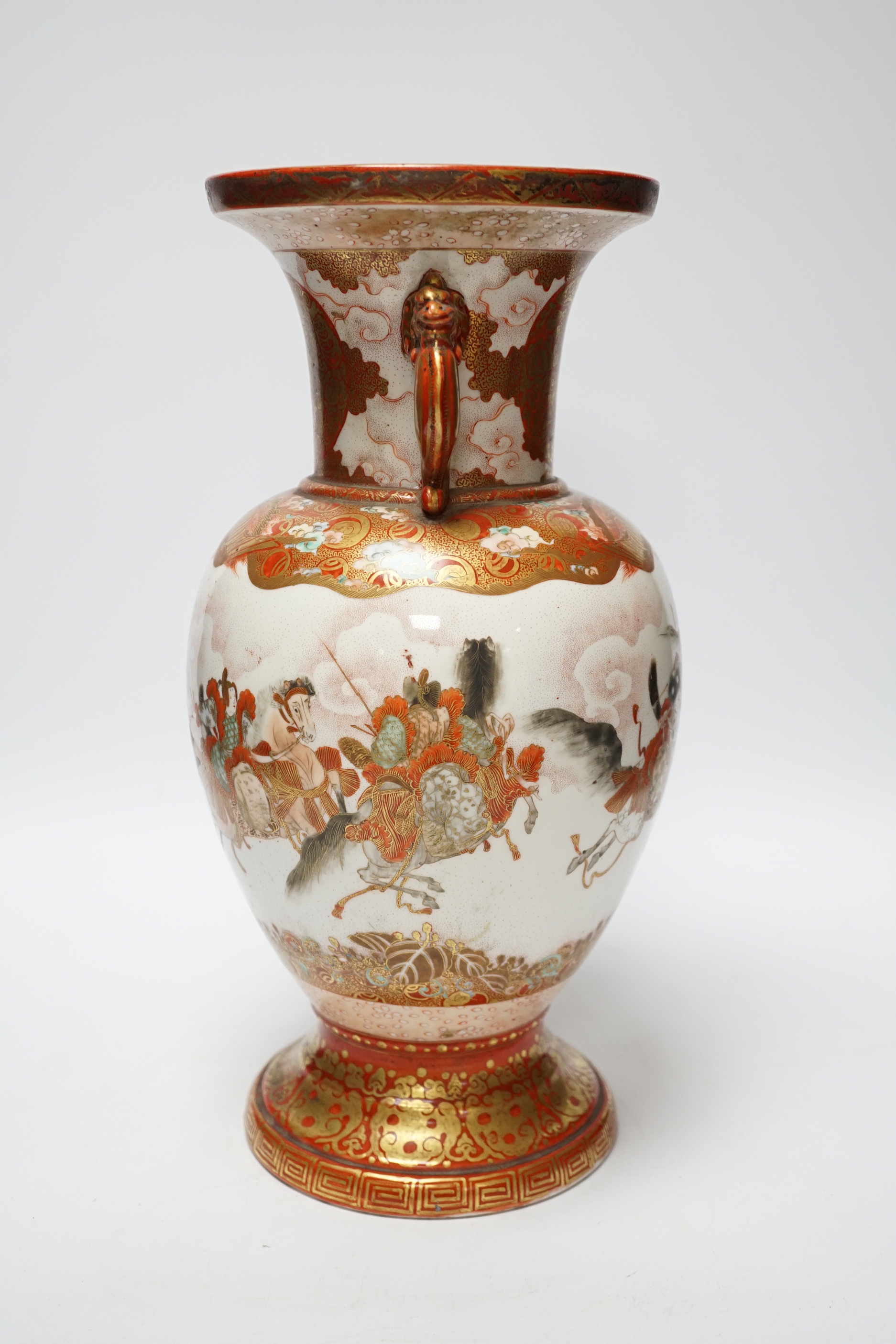 A Japanese Kutani porcelain twin handled vase, Meiji period, decorated with warriors on horseback, 34.5cm high